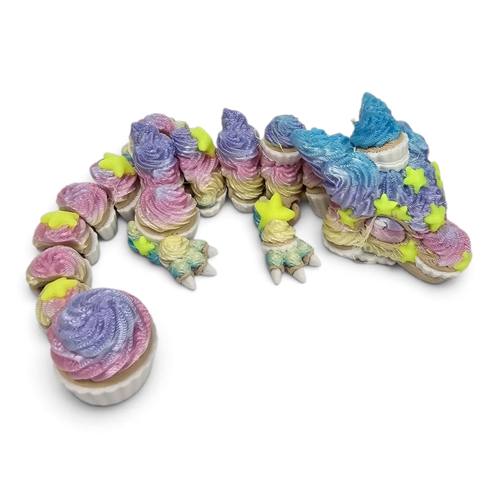 Made In Cobham articulated cupcake dragon figurine with pastel swirled frosting texture and bright yellow star accents.
