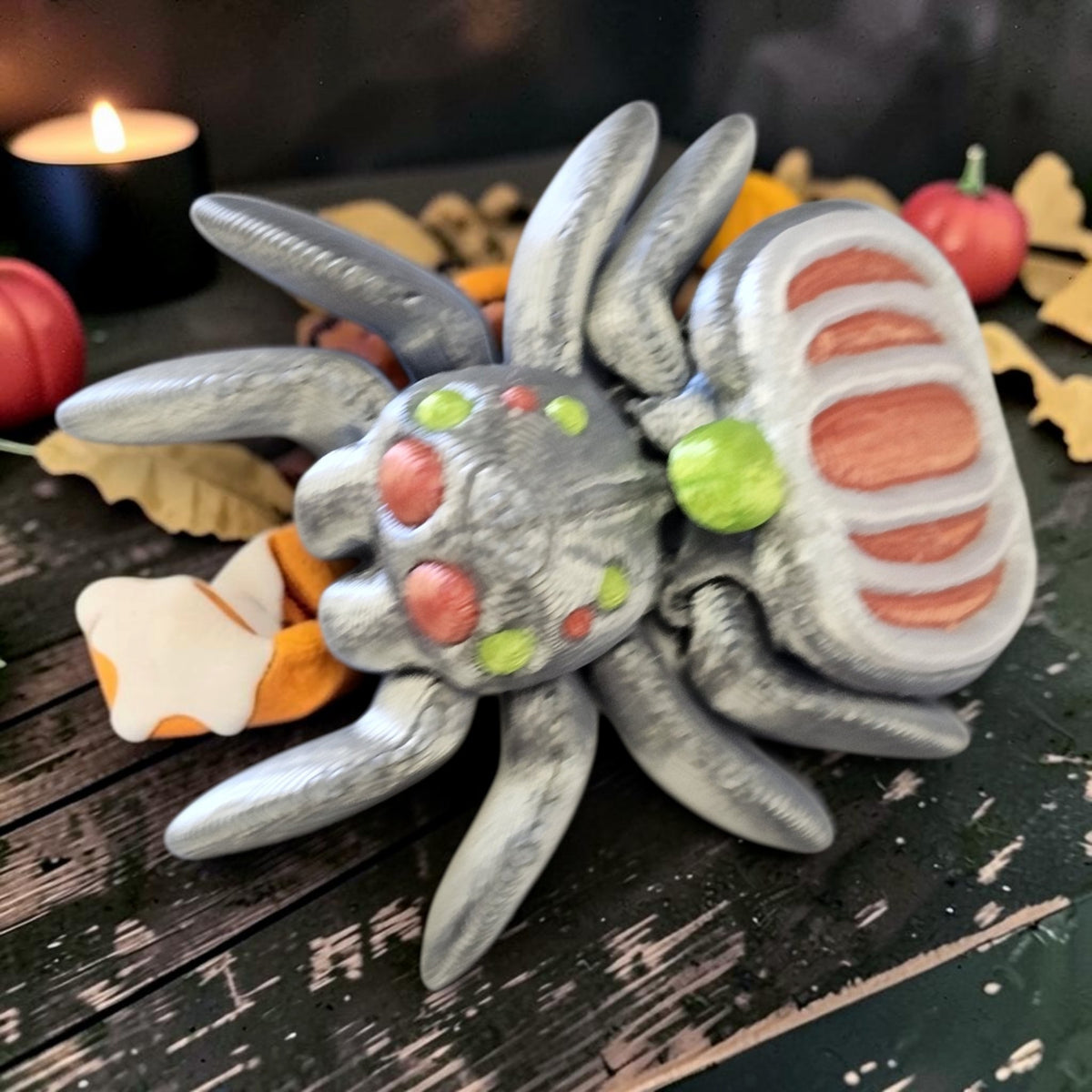 Made In Cobham articulated 3D-printed silver spider figurine with orange and green accents for Halloween decor